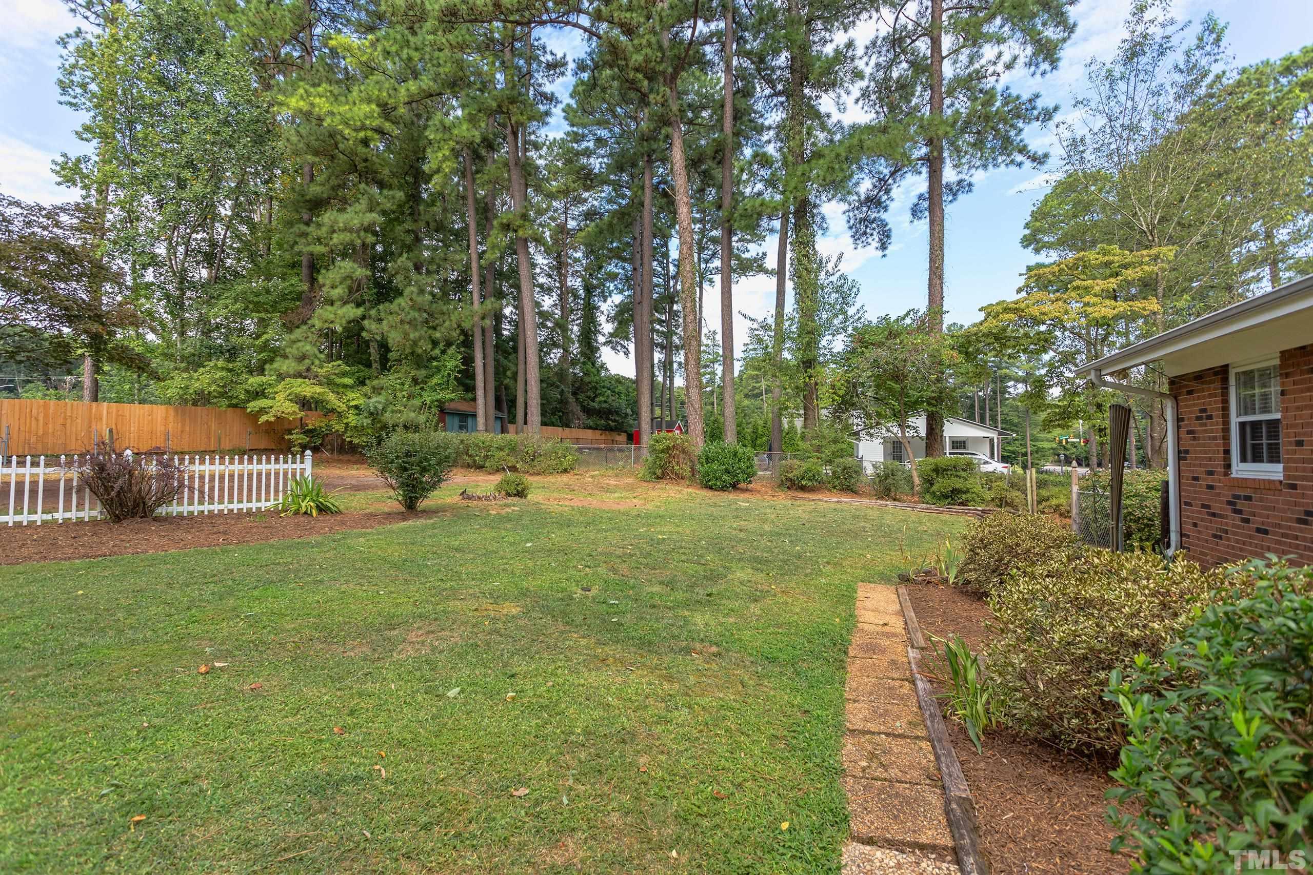 2312 Gresham Lake Road Raleigh, NC 27615 - Photo 31 of 46 a view of a garden with a house