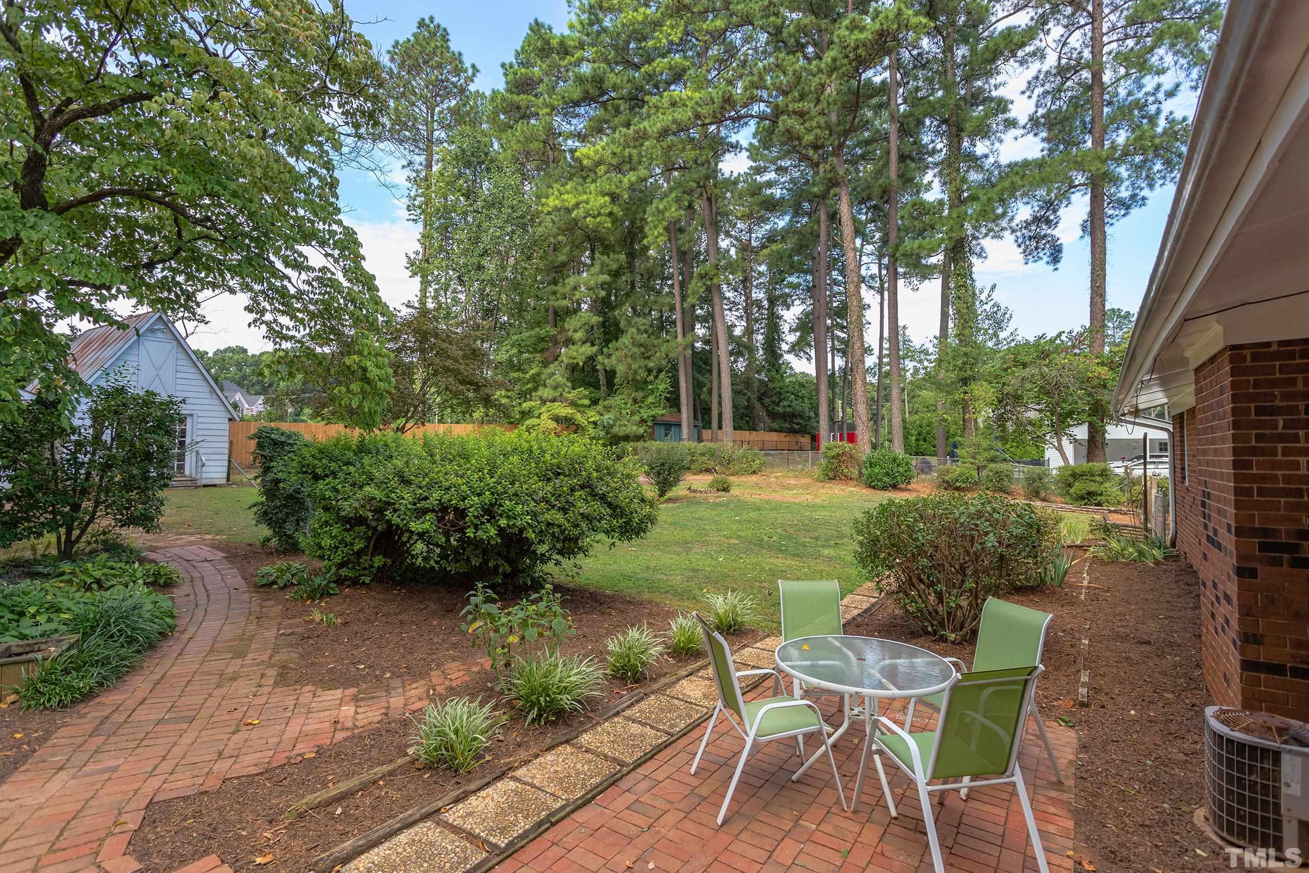 2312 Gresham Lake Road Raleigh, NC 27615 - Photo 32 of 46 a view of a chair and table in backyard of the house