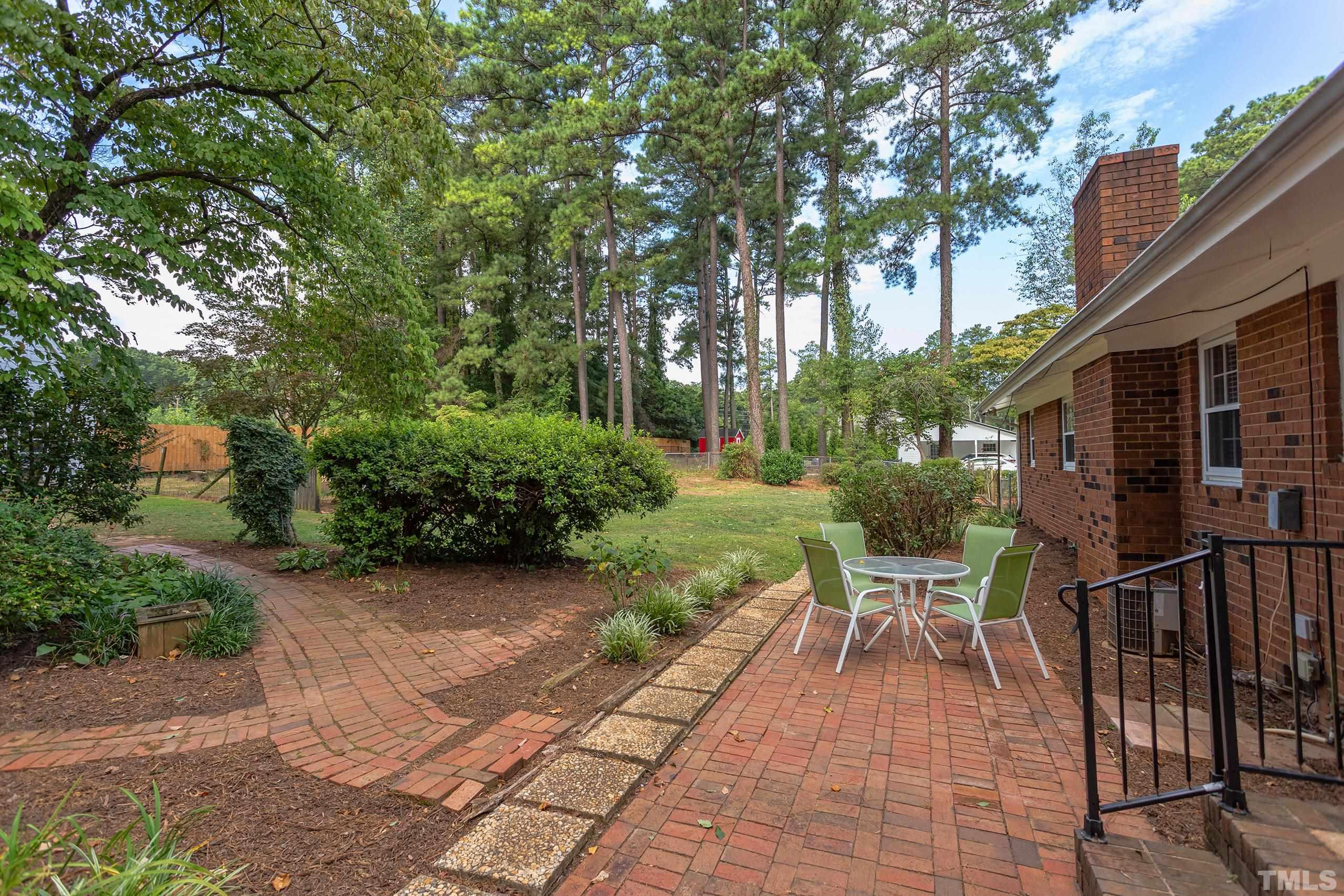 2312 Gresham Lake Road Raleigh, NC 27615 - Photo 33 of 46 a view of a chairs and table in backyard of the house