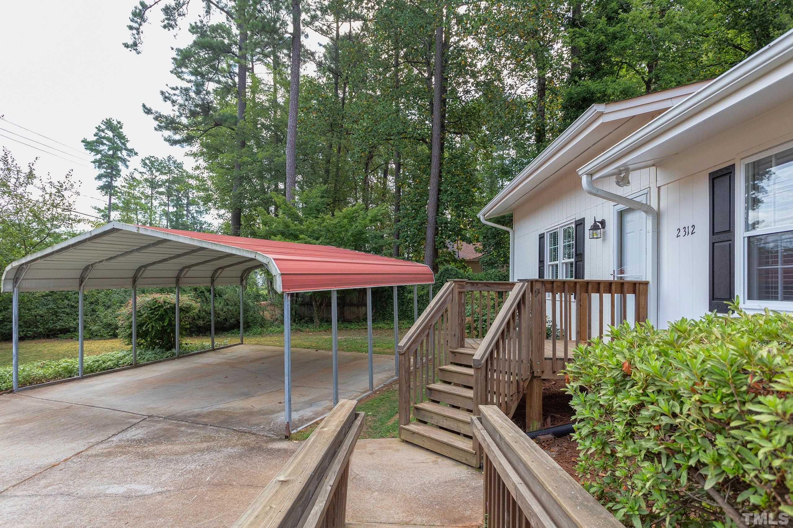 2312 Gresham Lake Road Raleigh, NC 27615 - Photo 44 of 46 a view of a wooden deck and a yard