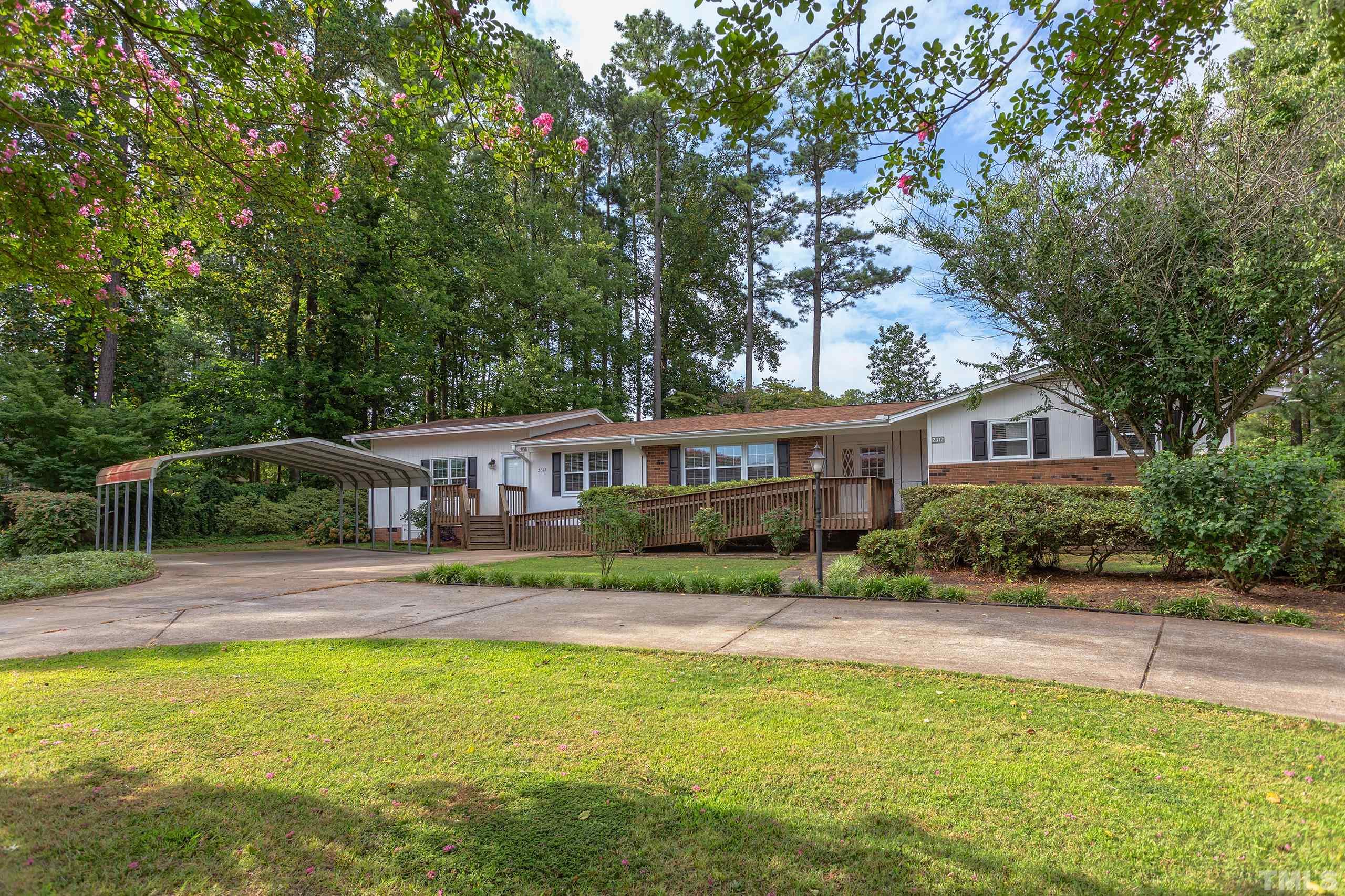 2312 Gresham Lake Road Raleigh, NC 27615 - Photo 46 of 46 a front view of a house with a yard table and chairs