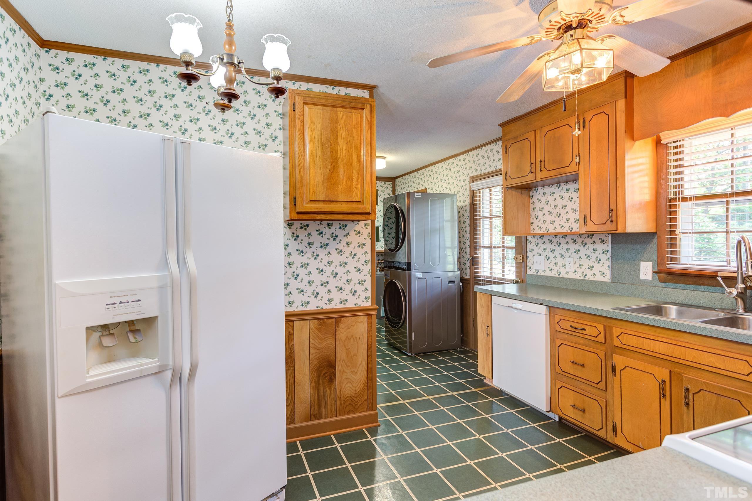 2312 Gresham Lake Road Raleigh, NC 27615 - Photo 5 of 46 a kitchen with stainless steel appliances a counter top space and a window