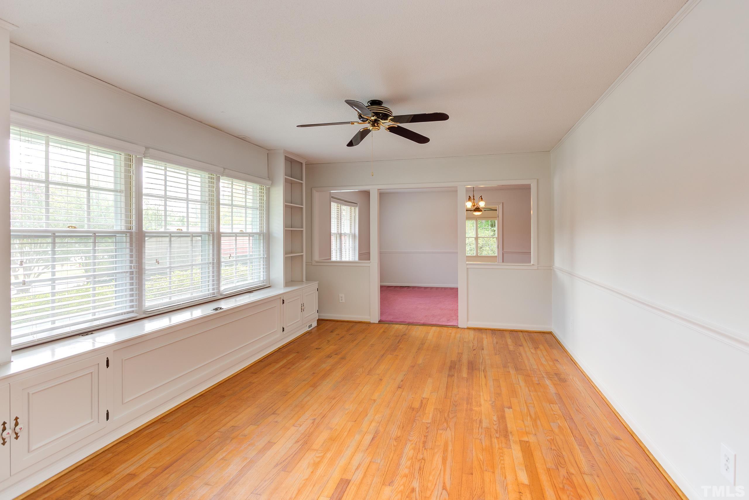 2312 Gresham Lake Road Raleigh, NC 27615 - Photo 8 of 46 a view of empty room with wooden floor and fan