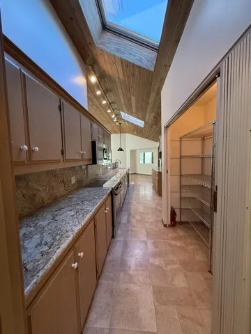 a bathroom with a tub a mirror and a shower