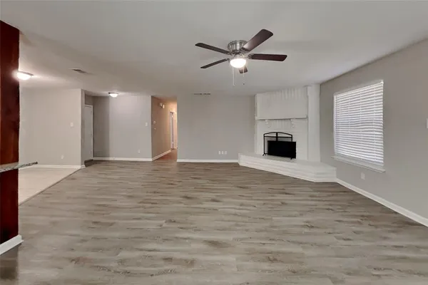 a view of a livingroom with a ceiling fan and window