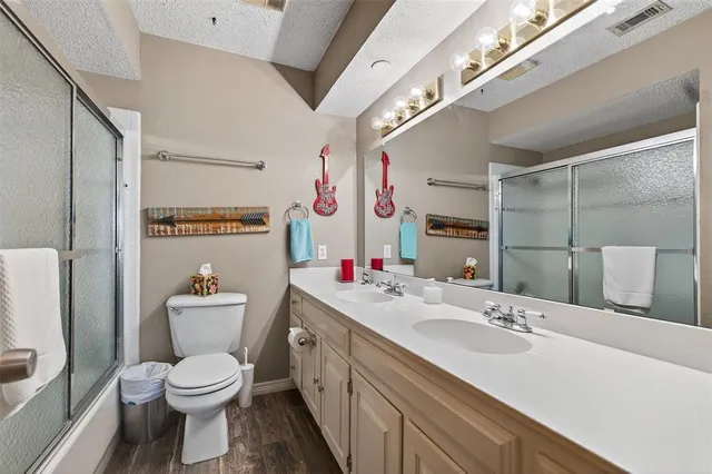 a spacious bedroom with a bed and a chandelier