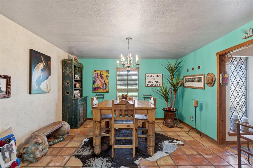 3030 Wager Road Flower Mound, TX 75028 - Photo 15 of 39 a view of a dining room with furniture and chandelier