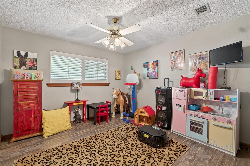 3030 Wager Road Flower Mound, TX 75028 - Photo 22 of 39 a room with furniture a chandelier and a flat screen tv