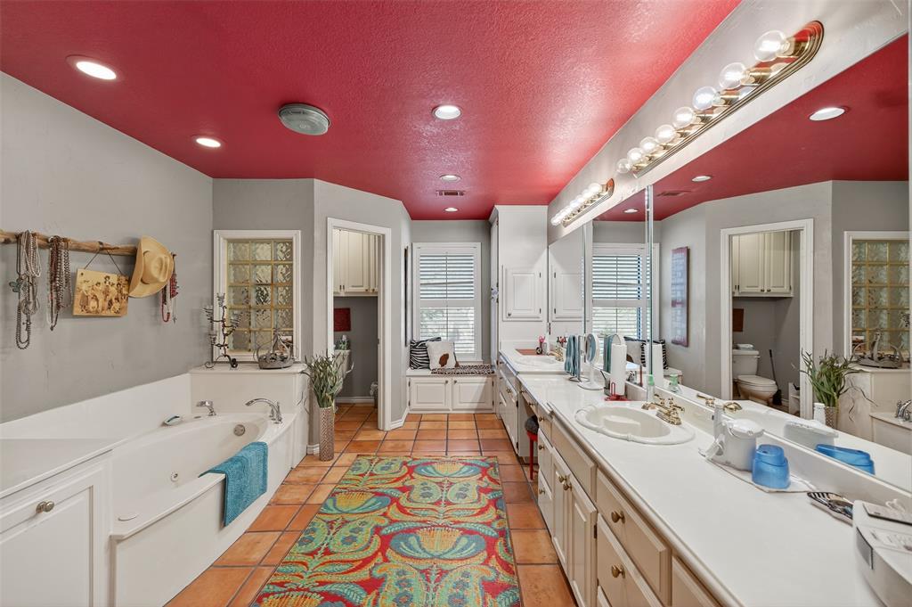 3030 Wager Road Flower Mound, TX 75028 - Photo 27 of 39 a bathroom with a sink a large mirror and a bathtub