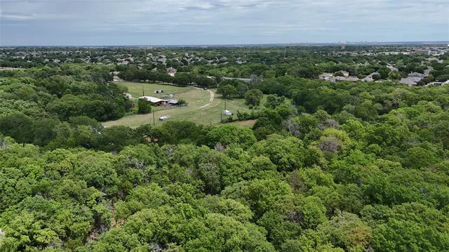 an aerial view of a houses with a yard