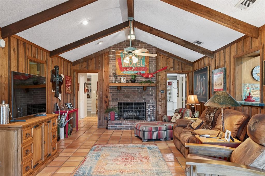 3030 Wager Road Flower Mound, TX 75028 - Photo 9 of 39 a living room with furniture a flat screen tv and a fireplace