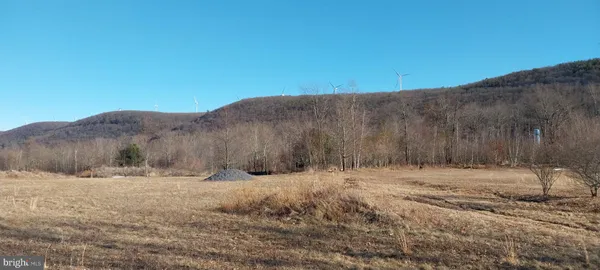 a view of dirt road with a dry background
