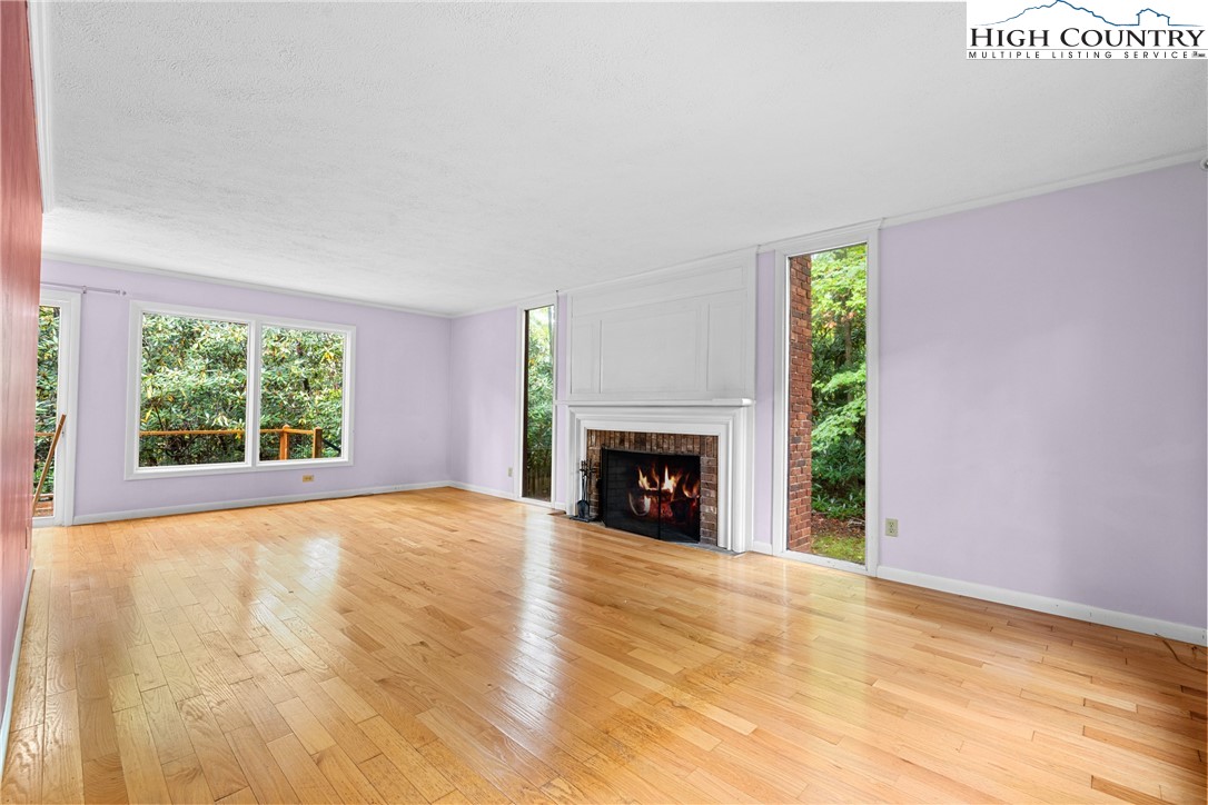 547 Deck Hill Road Boone, NC 28607 - Photo 14 of 50 a view of an empty room with a window and a fireplace