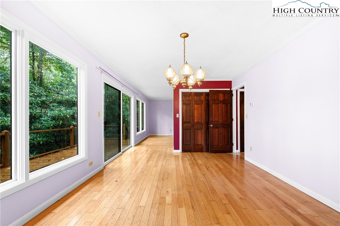 547 Deck Hill Road Boone, NC 28607 - Photo 17 of 50 a view of a room with a chandelier and wooden floor