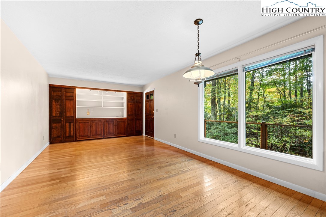 547 Deck Hill Road Boone, NC 28607 - Photo 19 of 50 a view of empty room with wooden floor and fan