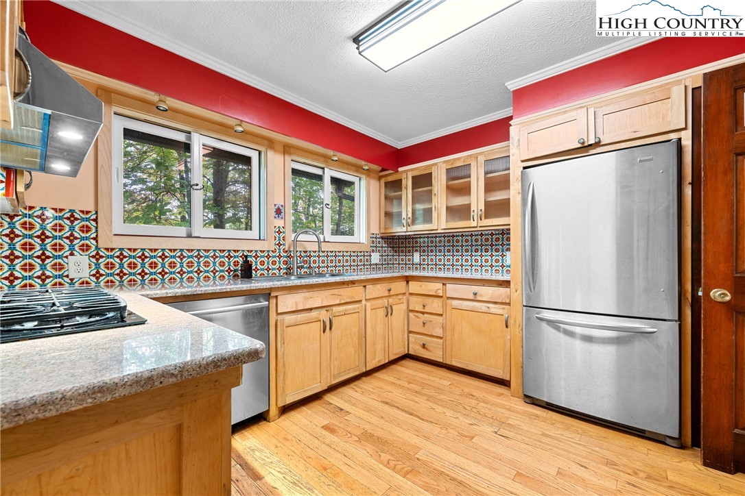 547 Deck Hill Road Boone, NC 28607 - Photo 21 of 50 a kitchen with granite countertop stainless steel appliances a stove and a refrigerator