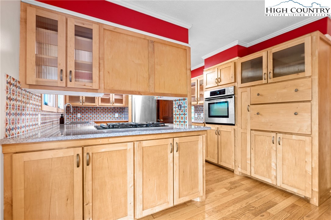 547 Deck Hill Road Boone, NC 28607 - Photo 22 of 50 a kitchen with stainless steel appliances granite countertop a stove and a microwave