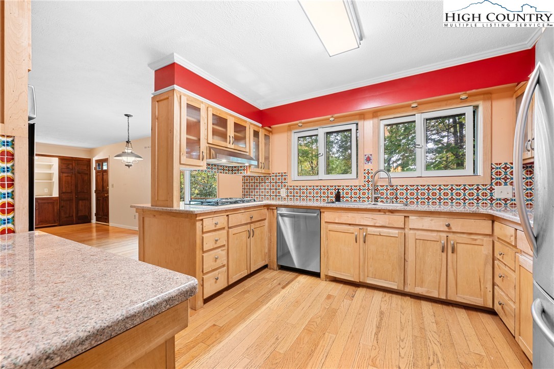 547 Deck Hill Road Boone, NC 28607 - Photo 23 of 50 a kitchen with stainless steel appliances granite countertop a stove a sink and a microwave