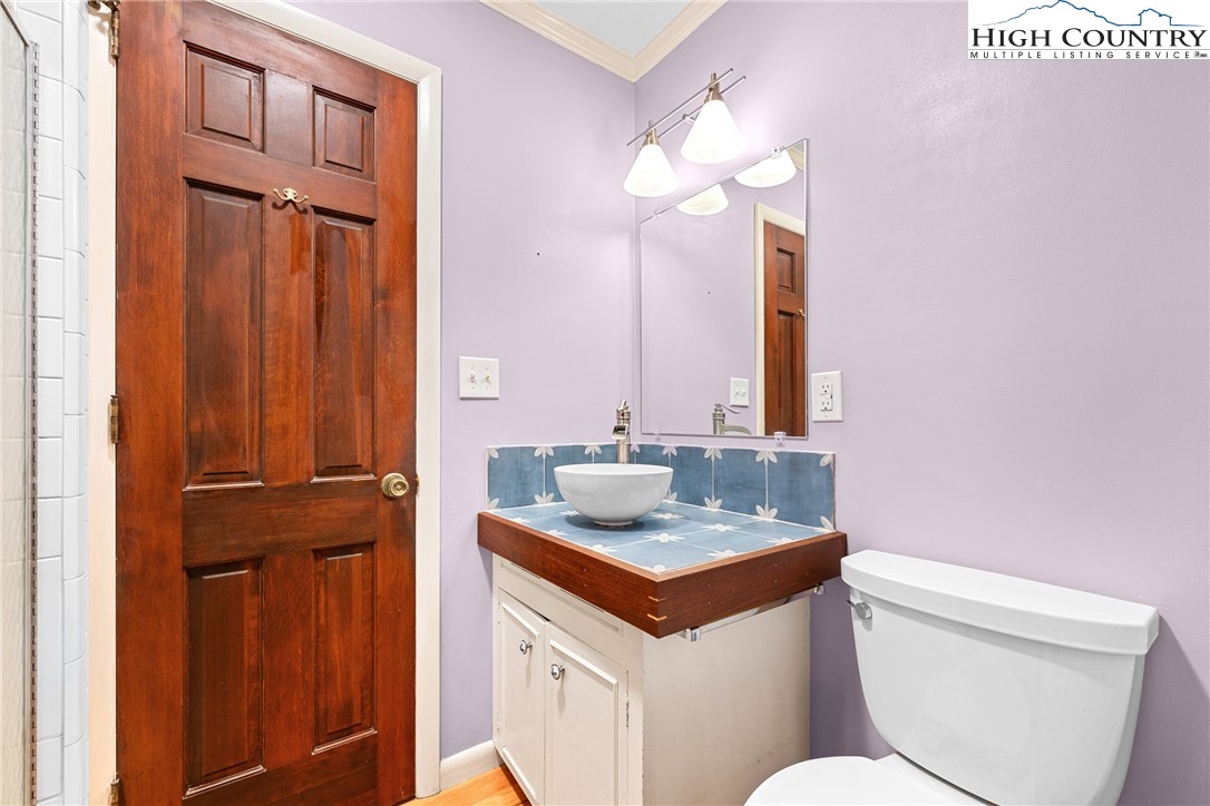 547 Deck Hill Road Boone, NC 28607 - Photo 26 of 50 a bathroom with a toilet sink and mirror