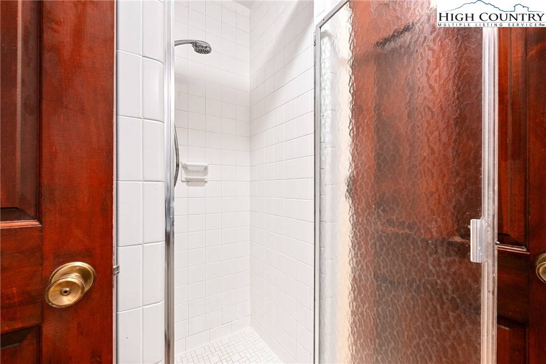 547 Deck Hill Road Boone, NC 28607 - Photo 27 of 50 a bathroom with a shower and a door
