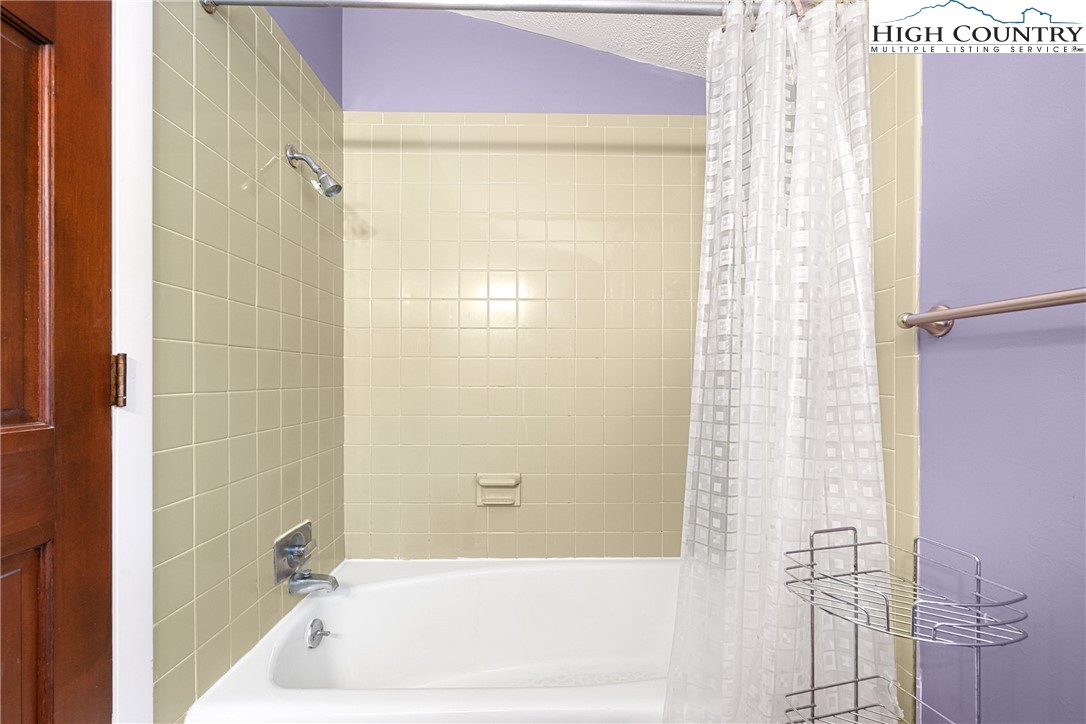 547 Deck Hill Road Boone, NC 28607 - Photo 39 of 50 a bathroom with a bathtub and shower