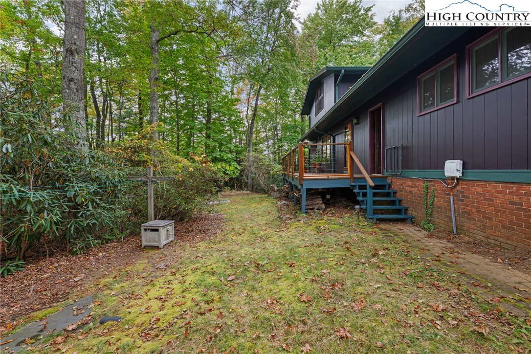 547 Deck Hill Road Boone, NC 28607 - Photo 4 of 50 a view of a wooden chairs and table in the backyard