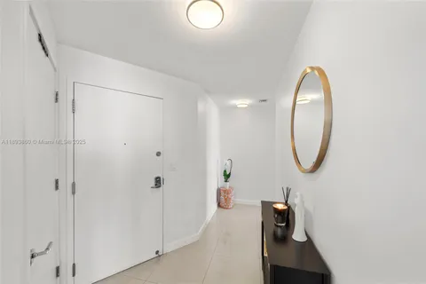 a bedroom with a bed and a flat tv screen next to a window