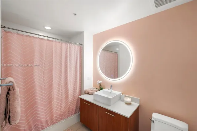 a bedroom with a bed and large windows