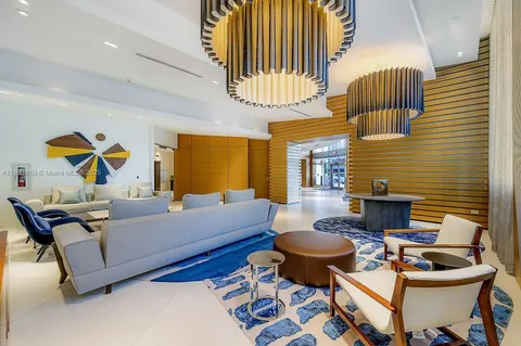 a living room with furniture and a lamp