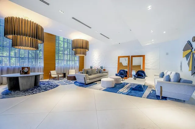 a living room with furniture and lamp