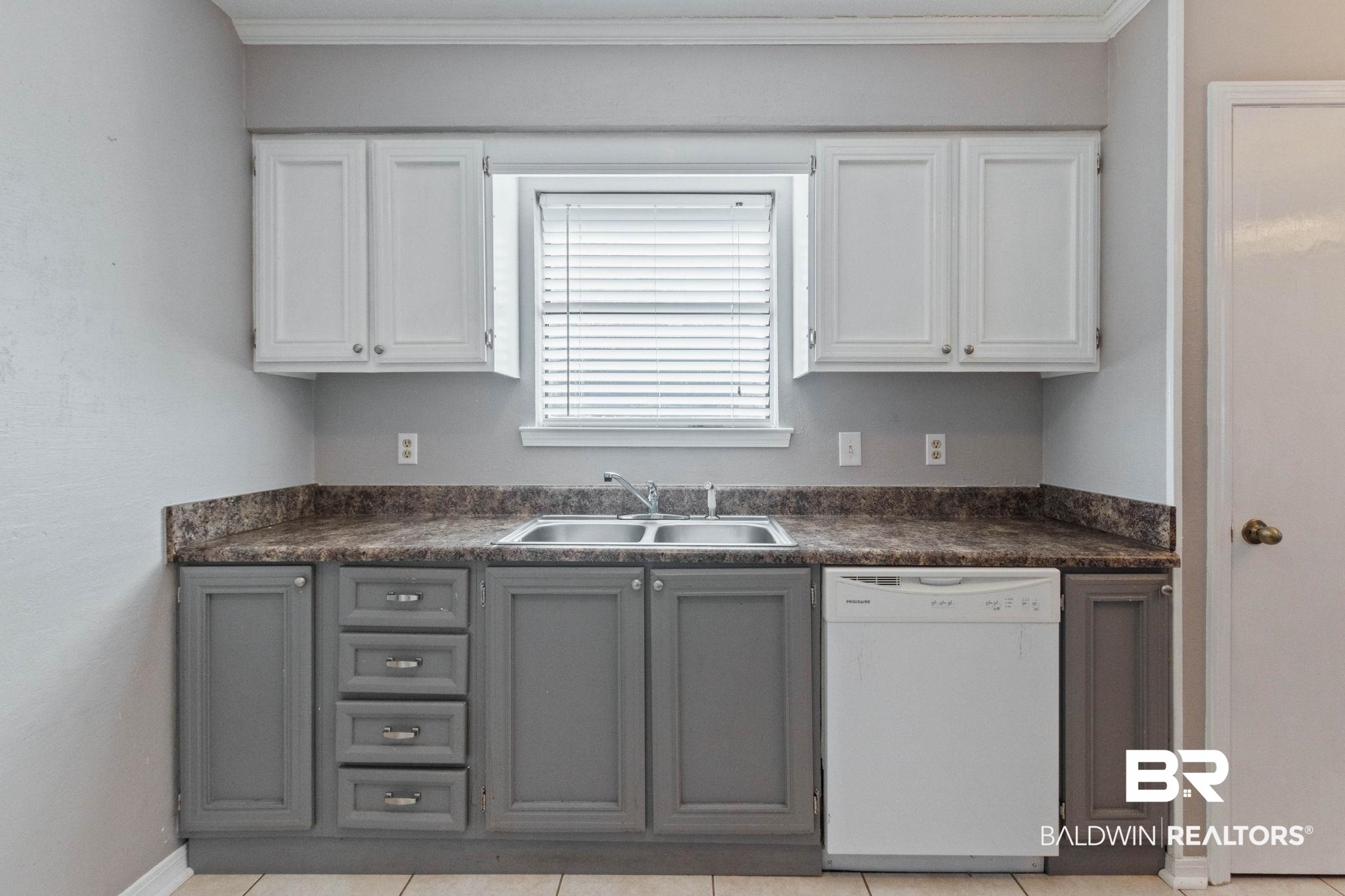 5366 Scanlan Way West Satsuma, AL 36572 - Photo 11 of 43 Dual tone kitchen with white dishwasher, dark countertops, ornamental molding, and two tone cabinets