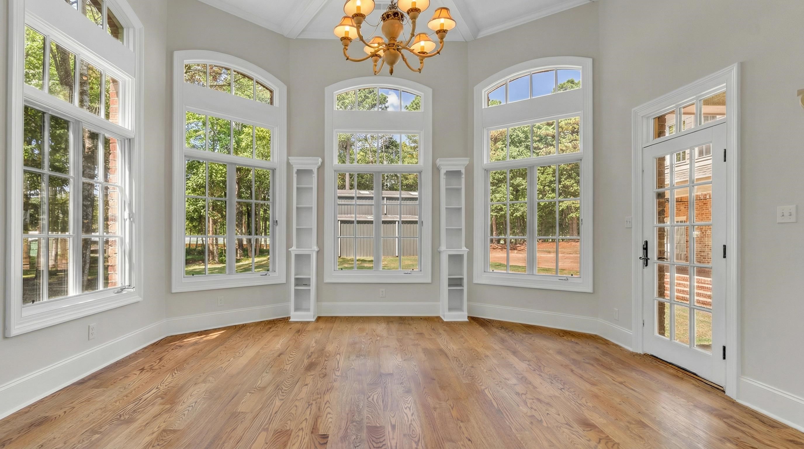 815 Dent Road Eads, TN 38028 - Photo 20 of 40 Unfurnished sunroom with suspended lighting, crown molding, and wood finished floors