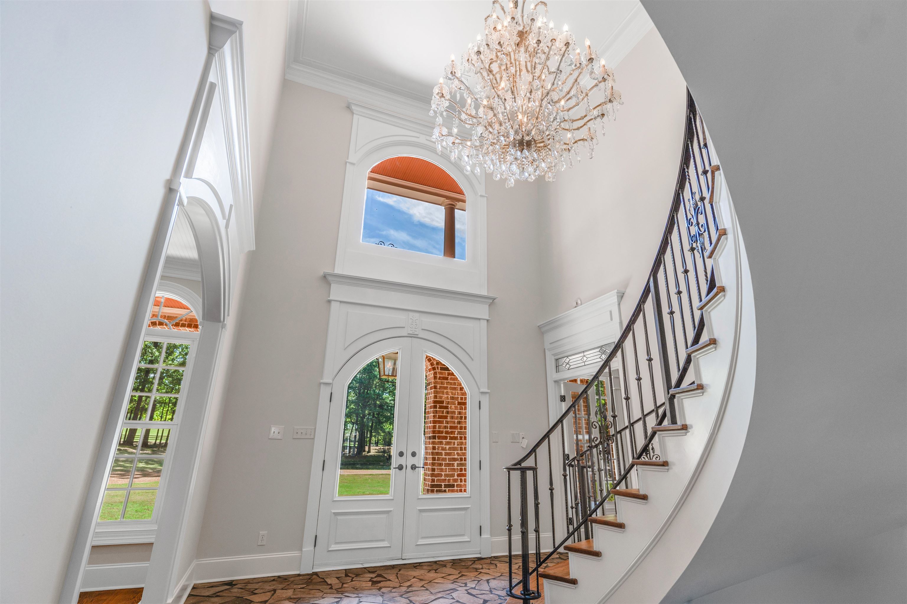 815 Dent Road Eads, TN 38028 - Photo 3 of 40 Entrance foyer featuring crown molding, a towering ceiling, french doors, a chandelier, and stairs