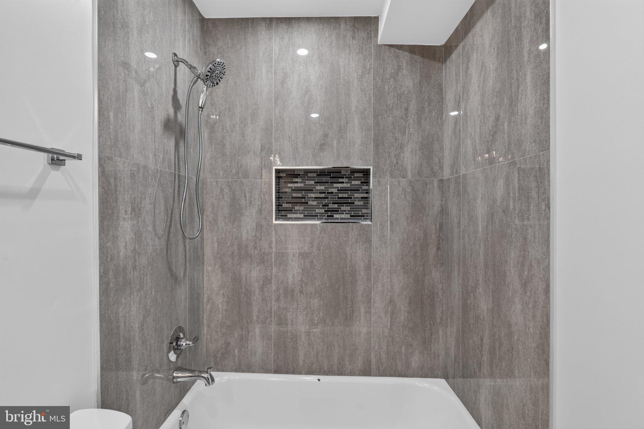 1650 Columbia Road Northwest, Unit 402 Washington, DC 20009 - Photo 14 of 19 Sleek modern shower with elegant tiles.