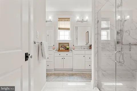 a bathroom with a shower sink and mirror