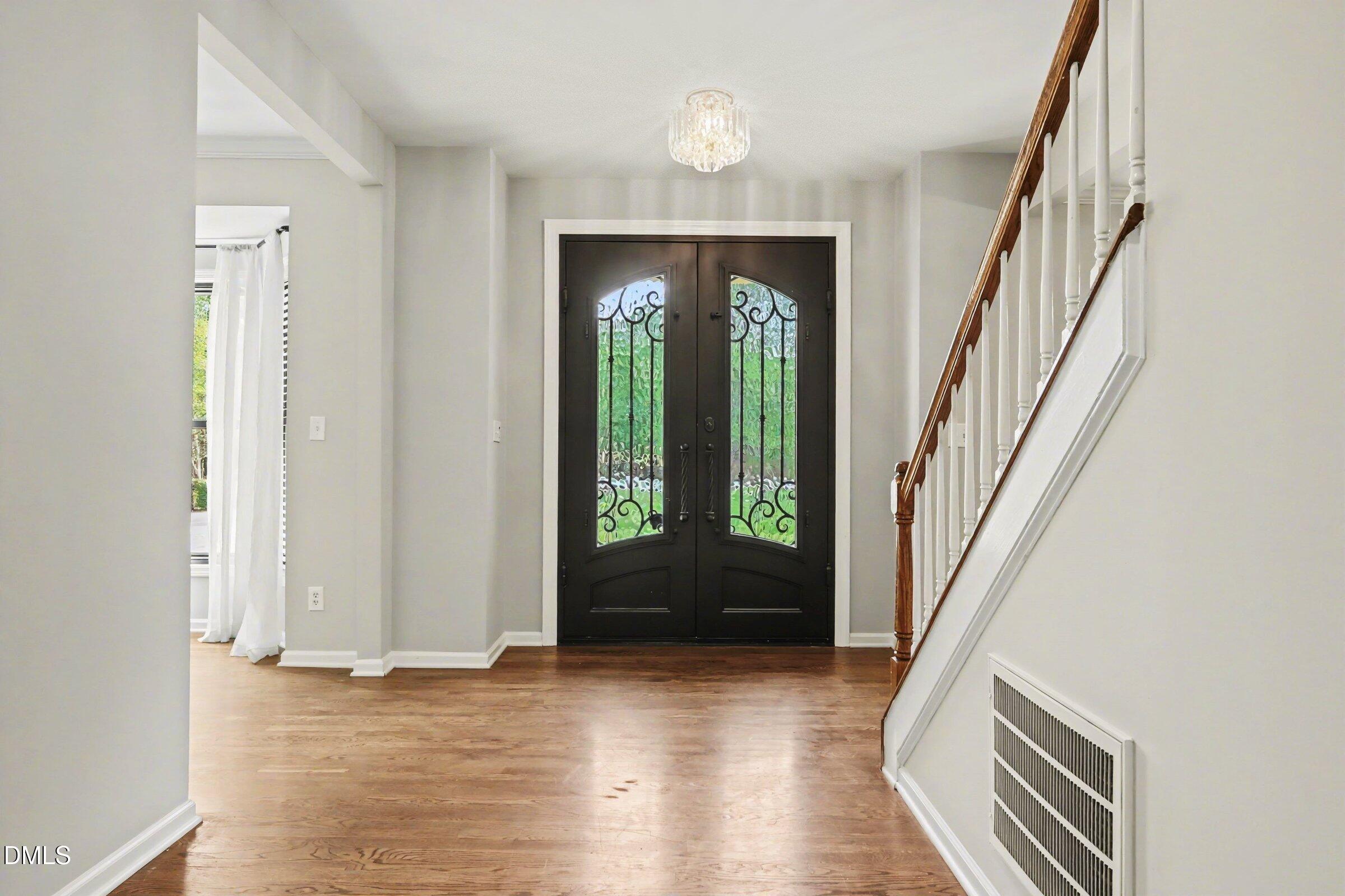 1001 Denfield Court Raleigh, NC 27615 - Photo 9 of 44 wooden floor in an empty room with a window