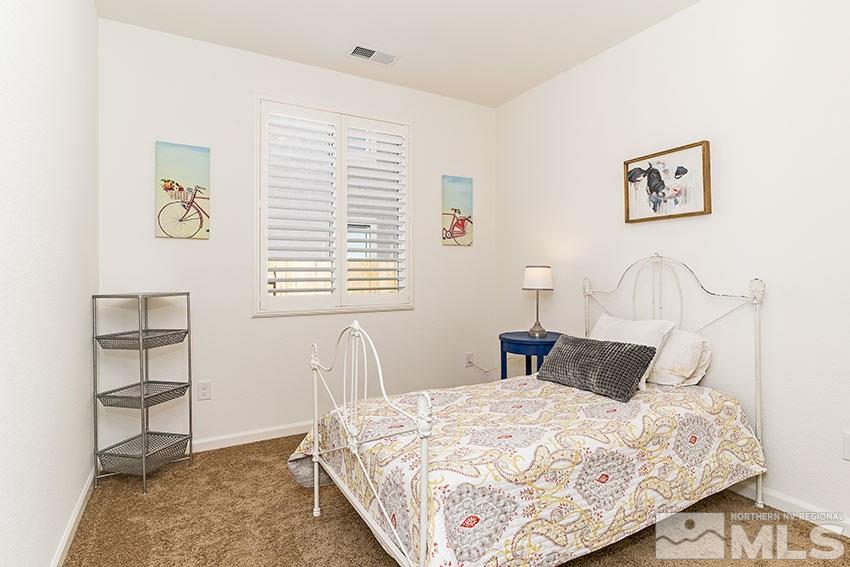 9260 Peninsula Court Reno, NV 89506 - Photo 14 of 25 a bedroom with a bed and a window