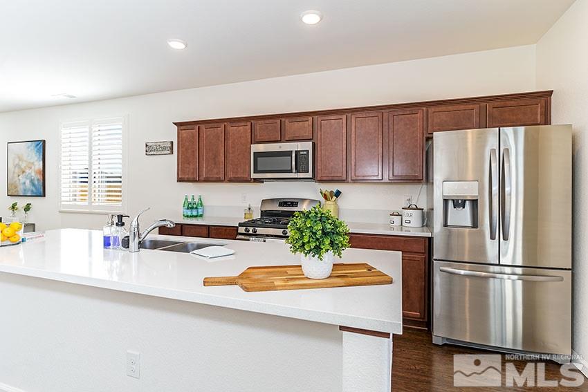 9260 Peninsula Court Reno, NV 89506 - Photo 10 of 25 a kitchen with refrigerator and a sink