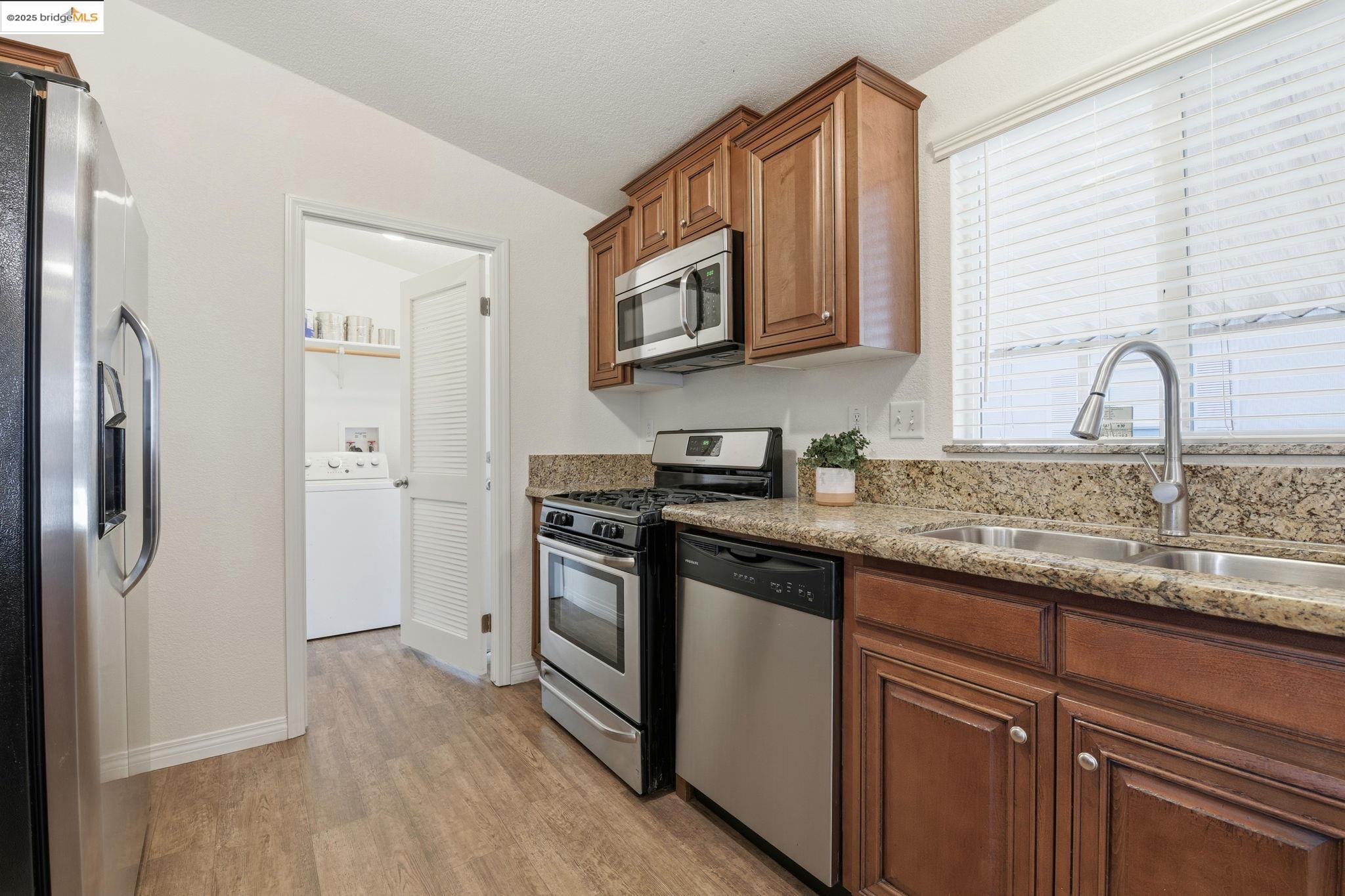 16711 Marsh Creek Road, Unit 111 Clayton, CA 94517 - Photo 12 of 34 a kitchen with stainless steel appliances granite countertop a refrigerator and a sink