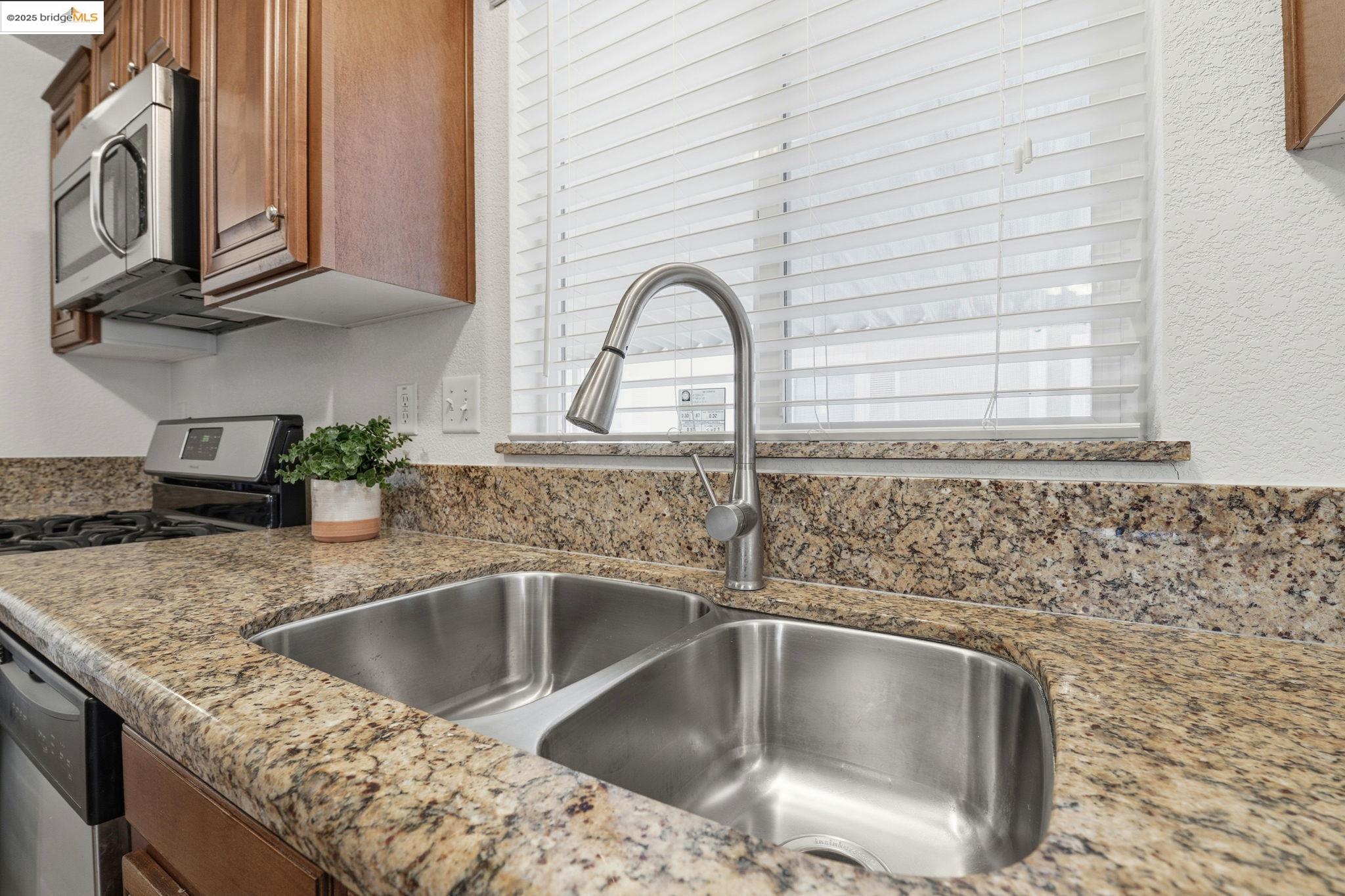 16711 Marsh Creek Road, Unit 111 Clayton, CA 94517 - Photo 13 of 34 a kitchen with granite countertop a sink and a stove