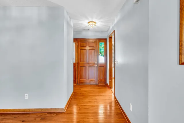 a view of a room with wooden floor and a bathroom