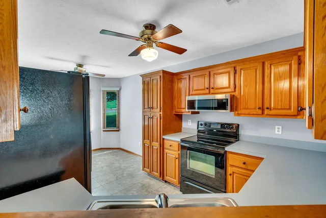 a kitchen with stainless steel appliances granite countertop a stove and a refrigerator