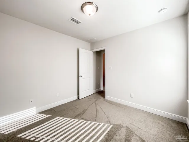 a view of a room with wooden floor and white walls