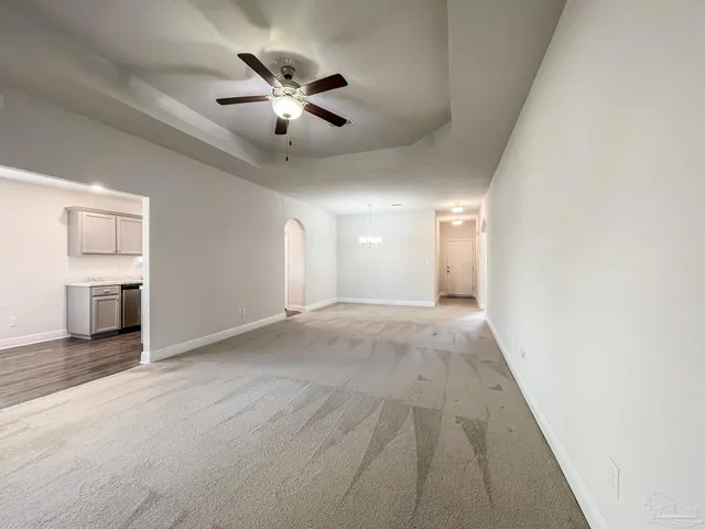 a view of a livingroom with a ceiling fan and window