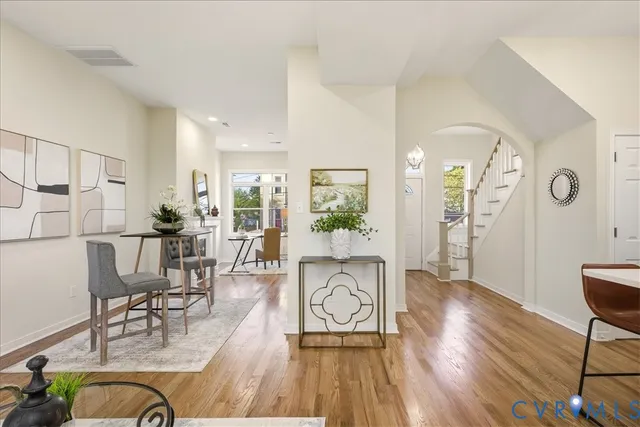 a living room with furniture a wooden floor and a large window