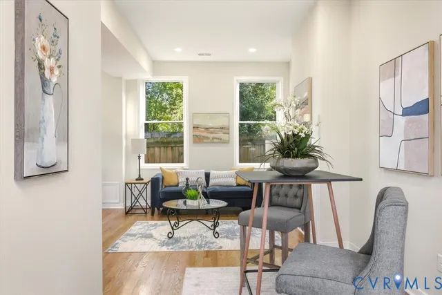 a living room with furniture and a potted plant