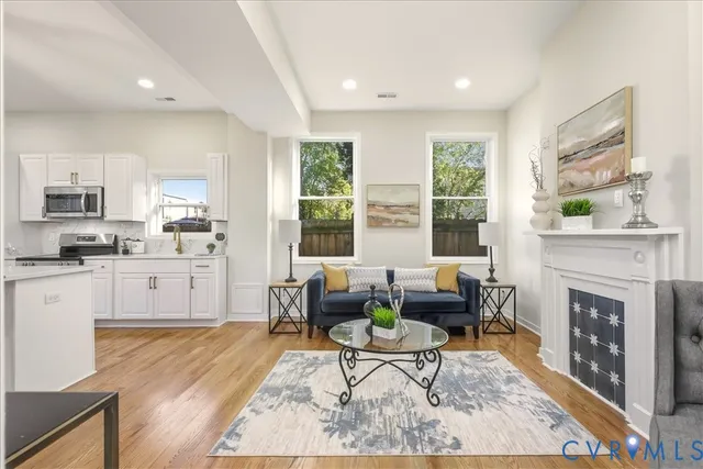 a living room with furniture kitchen and a table