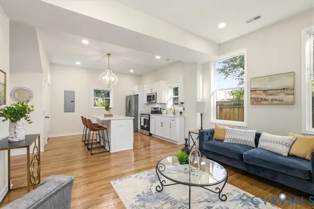 a living room with kitchen island furniture and a kitchen view