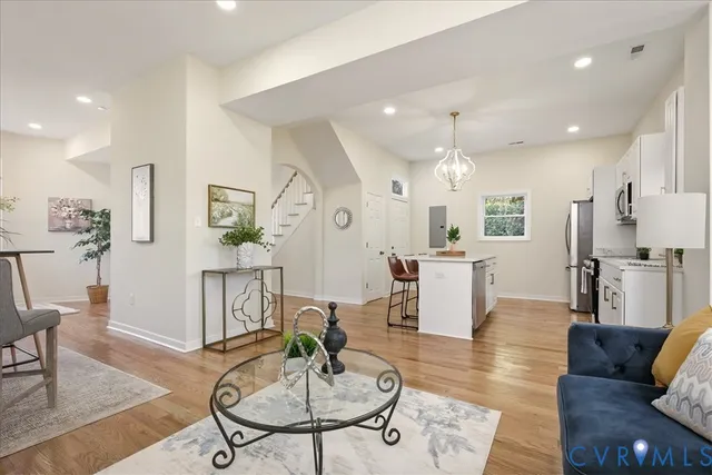 a living room with furniture and a potted plant