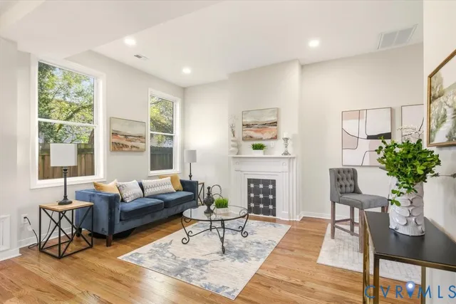 a kitchen with stainless steel appliances kitchen island granite countertop a sink refrigerator and cabinets